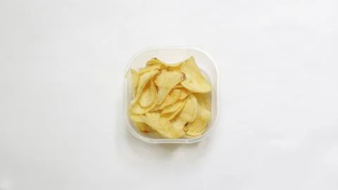 Crispy potato chips served in a plastic square bowl 写真素材