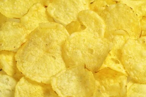 Crispy potato chips snack texture, food background, close-up Stock Photos