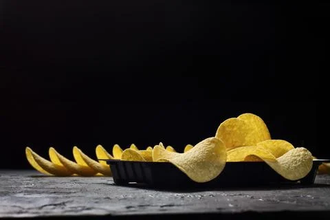 Crispy potato chips on a stone background Stock-Fotos