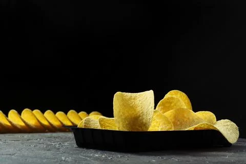 Crispy potato chips on a stone background Stock-Fotos