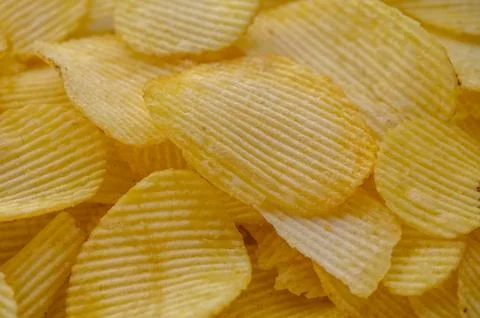 Crispy potato chips texture background top view Stock Photos