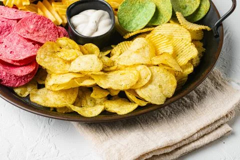 Crispy potato chips on white stone table background Stock Photos