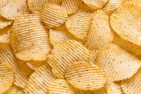 Crispy potatoes chips isolated on white background. Food background. Foto stock