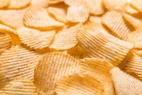 Crispy potatoes chips isolated on white background. Food background. Foto stock