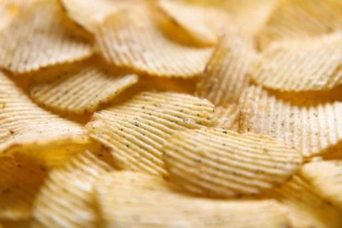 Crispy potatoes chips isolated on white background. Food background. Foto stock