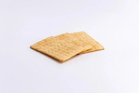 Crispy rectangular cheese crackers biscuits isolated on a white background Stock Photos