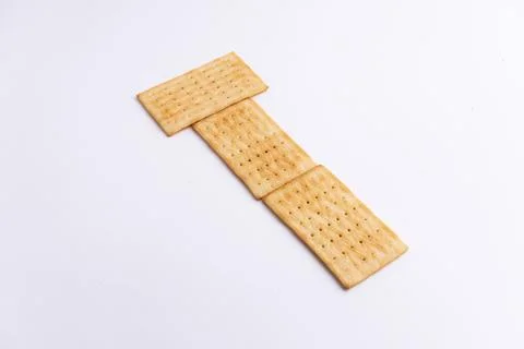Crispy rectangular cheese crackers biscuits isolated on a white background Stock Photos