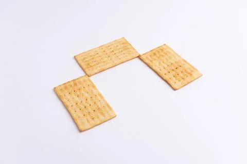 Crispy rectangular cheese crackers biscuits isolated on a white background Stock Photos