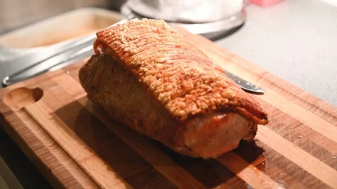 Crispy roast pork placed on a cutting board  ready to be served Stock Footage 116228978