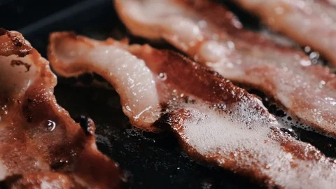 Crispy, roasted bacon slices on a frying pan 스톡 동영상 102570243