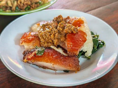 Crispy Roasted Pork Babi Guling Slices with Balinese Sambal Fotos Stock