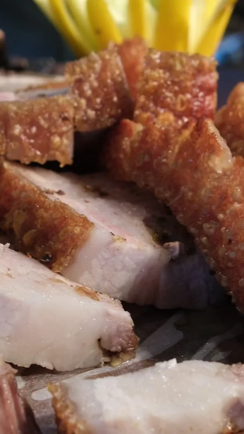 Crispy roasted pork belly cut into small pieces and arranged on a wooden tray Stock Footage 311926143