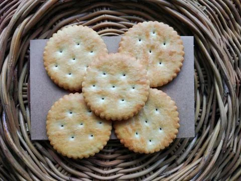 Crispy Round Crackers in a Wicker Basket Stock Photos
