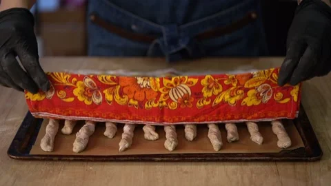 Crispy rye sticks sprinkled with flour. The baker covers the bread with a Stock Footage 159366532