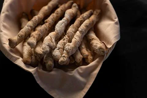 Crispy rye sticks sprinkled with flour. Rustic, laid out on a platter covered Stock Photos