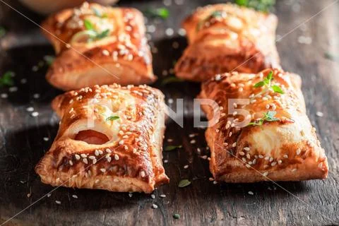 Crispy sausage in puff pastry with tatar sauce and herbs Stock Photos