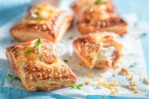 Crispy sausage in puff pastry with thyme and sesame seeds Stock Photos