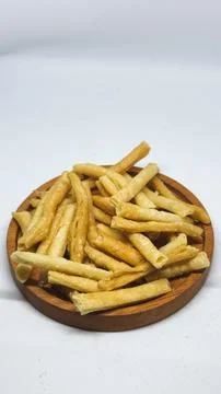 Crispy savory stick snacks served on a wooden plate on a desk Stock Photos