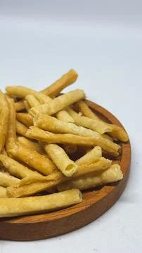 Crispy savory stick snacks served on a wooden plate on a desk Stock Photos