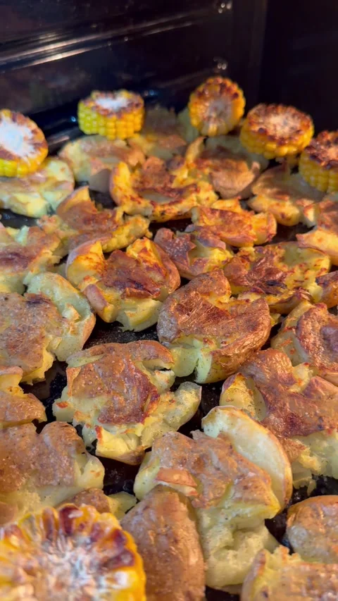Crispy Smashed Potatoes and Corn Baking in Oven Stock Footage 324901931