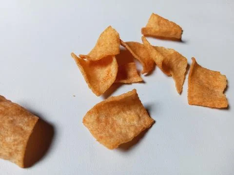 Crispy snack chips on white background. Фото