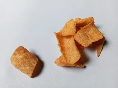 Crispy snack chips on white background. Фото