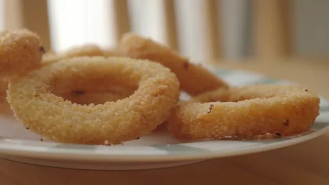 Crispy snack rings on a plate in a bright kitchen Stock Footage 336650927
