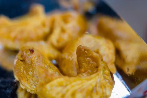 Crispy snack served on a metallic tray at a local market Stock Photos