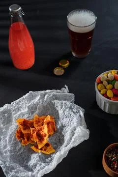 Crispy spicy pumpkin chips, dehydrated vegetable slices. Bowl of peanuts Stock Photos
