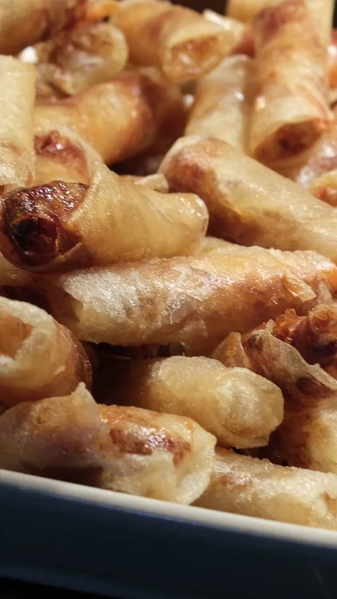 Crispy spring rolls Asian spring rolls frying in oil on a pan at a street food Stock Footage 317701909