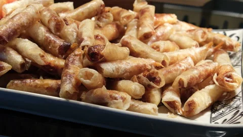 Crispy spring rolls Asian spring rolls frying in oil on a pan at a street food Stock Footage 317702655