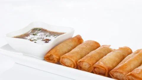 Crispy spring rolls on white dish with Sweet &amp; Sour Sauce. Stock Photos