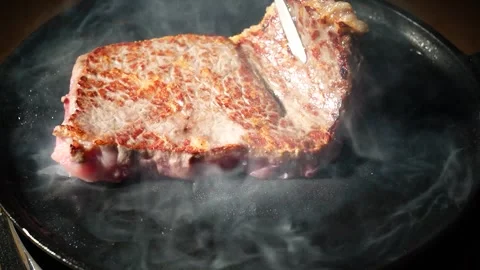 Crispy Steak Being Turned in Heated Pan 動画素材 334909370