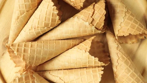 Crispy sweet empty waffle cones background Stock Footage 335560194
