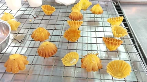 Crispy Thai flower pastry cups Krathong Thong on a cooling rack. Stock Footage 343211366