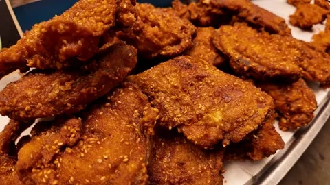 Crispy Thai Fried Chicken Display on Street Food Stall Tray 4K Video stock 331239295