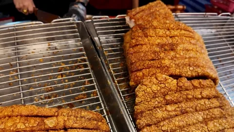 Crispy Thai Pork Belly Displayed at Street Food Market Stall in 4K Видео 340204443
