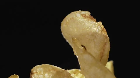 Crispy thin potato chips close-up on a dark background Stock Footage 135230771