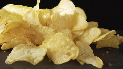 Crispy thin potato chips close-up on a dark background 스톡 동영상 135231390