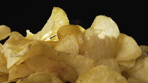 Crispy thin potato chips close-up on a dark background Video stock 135231907