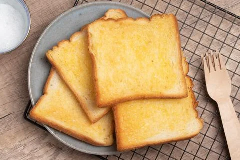Crispy Toasted Bread with Butter and Sugar Stock Photos