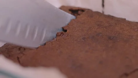 Crispy Top of Freshly Baked Chocolate Brownie being Cut and Cracking as Knife Stock Footage 342273185