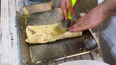 Crispy traditional bread baked local food herbs butter ghee Iran kalaneh Stock Footage 329553487