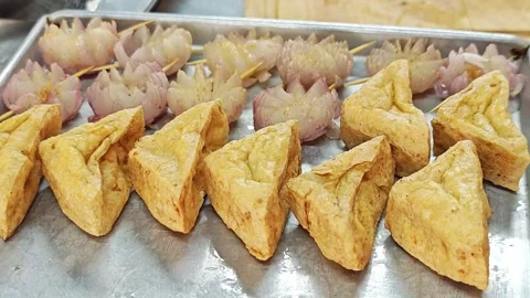 Crispy triangle fried tofu with carved flower shallots on on a tray/plate. Stock Footage 344560992