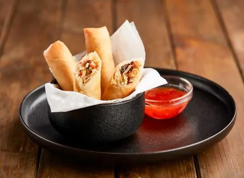 Crispy Vegetable Spring Rolls with Sweet Chili Dipping Sauce in plate side .. Stock Photos