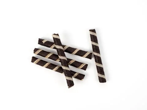 Crispy waffle rolls on a white background. Stock Photos