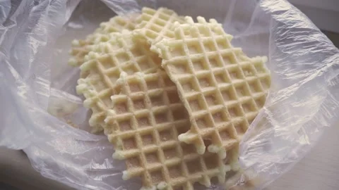 Crispy waffles in plastic bag. sweet homemade snack in harmful package. deliciou Stock Footage 161855538