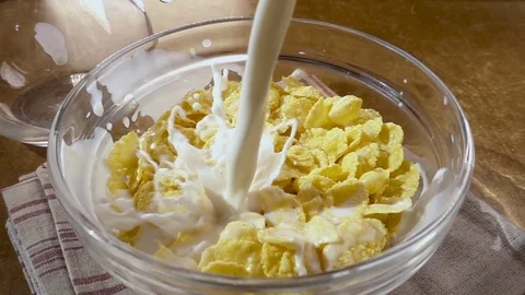 Crispy yellow corn flakes into the bowl for the morning a delicious Breakfast Stock Footage