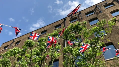 A criss cross of Union Jack flags blowing in the wind. Stockbeeldmateriaal 196486921