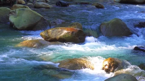 Cristal clear river flows around large stones in a Himalayan mountains illu.. 스톡 동영상 297261677